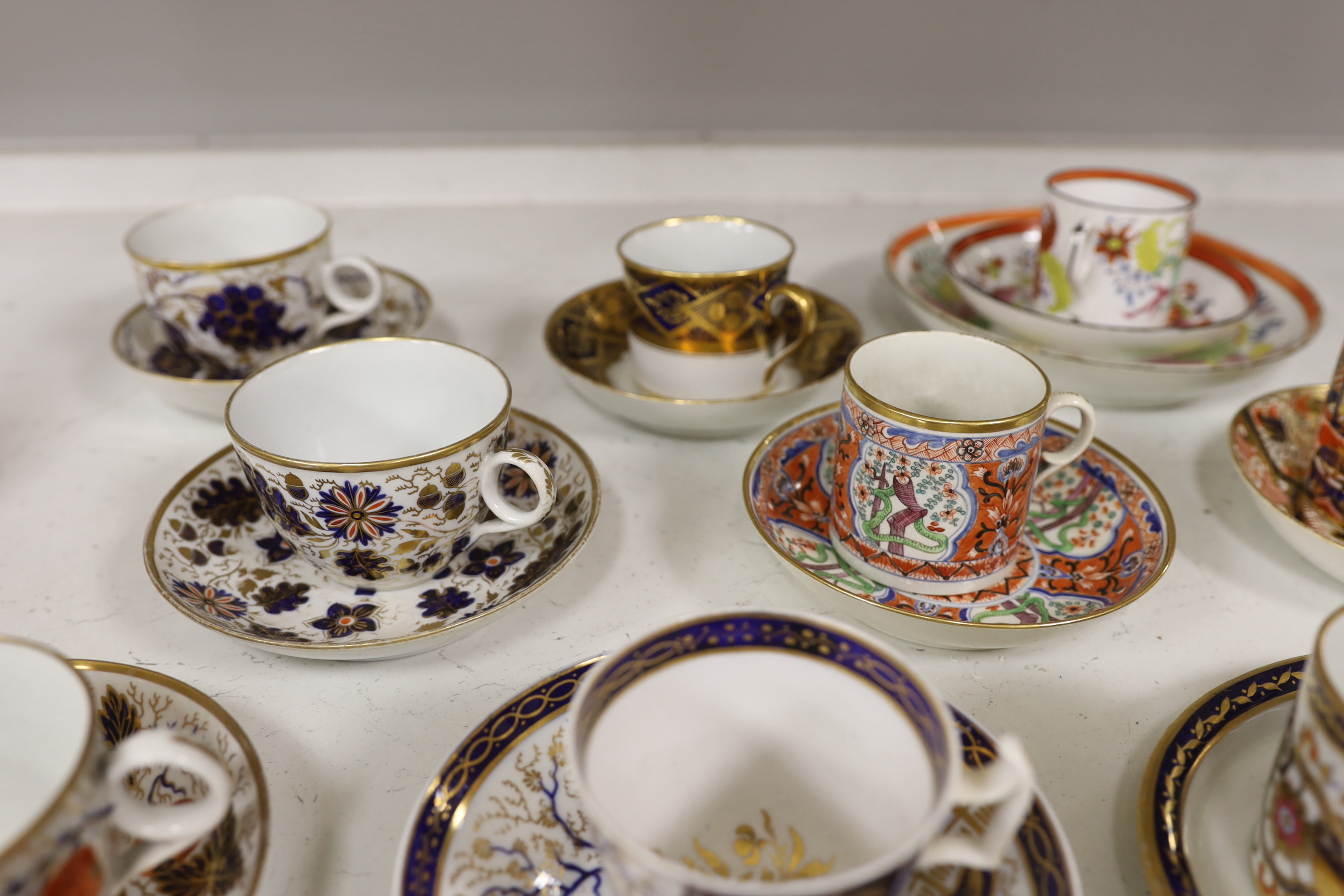 Six mixed English 1800-1820 porcelain cabinet cups and saucers, three similar coffee cans and saucers, a matching spoon stand and two coffee cans, a saucer dish, coffee can plus saucer and a tea bowl and matching saucer